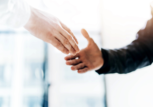 Business partnership meeting concept. Image businessmans handshake. Successful businessmen handshaking after good deal. Horizontal, blurred